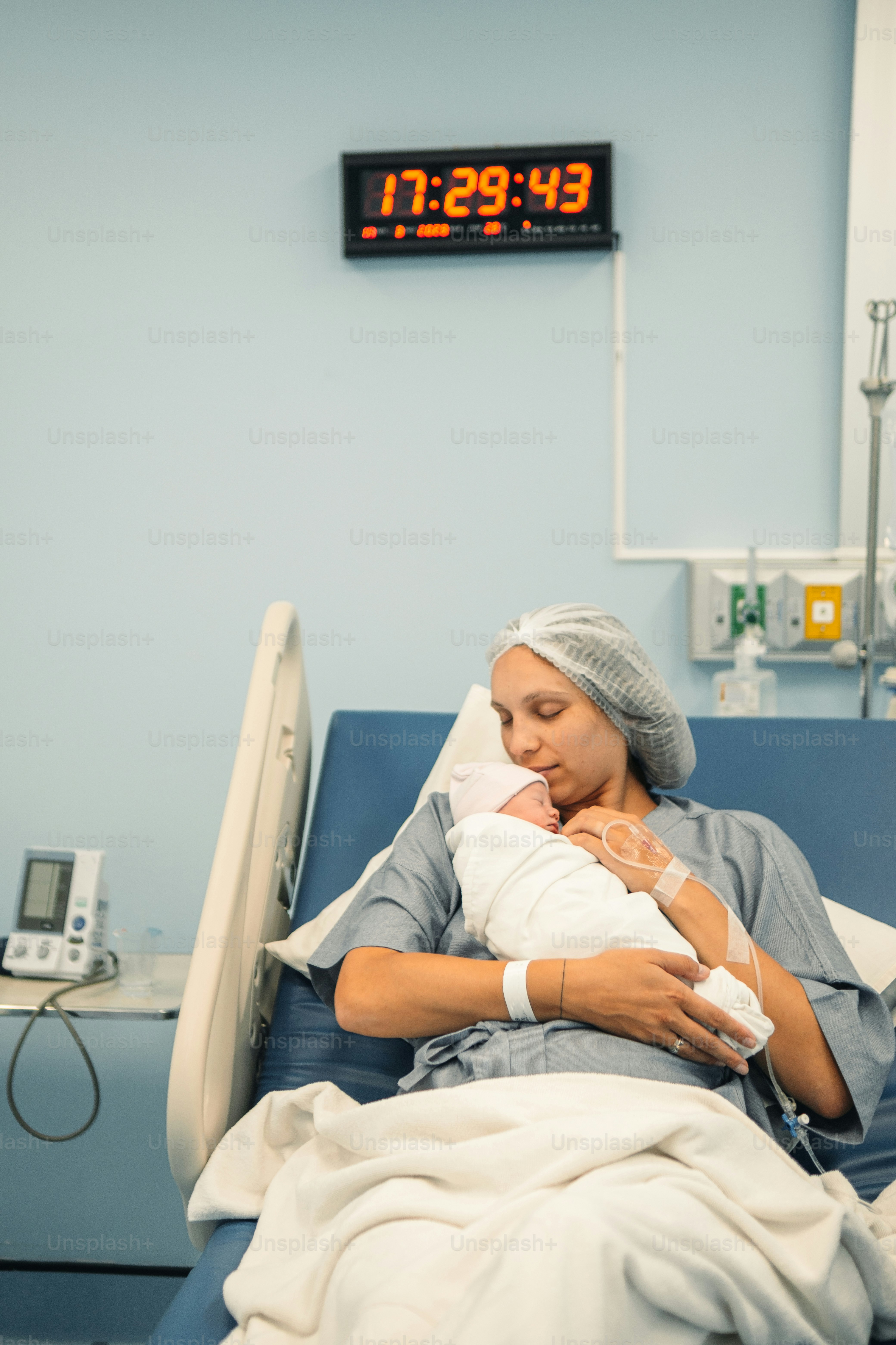 a woman in a hospital bed holding a baby