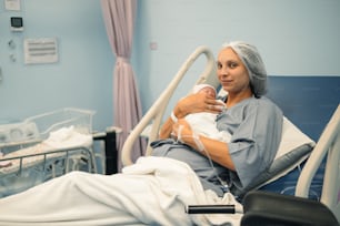 a woman in a hospital bed holding a baby