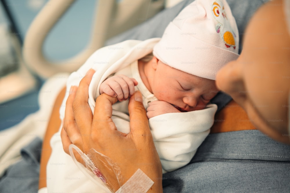 a woman holding a baby wrapped in a blanket