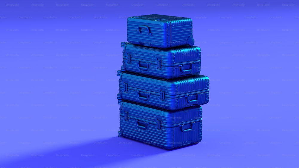 three blue suitcases stacked on top of each other