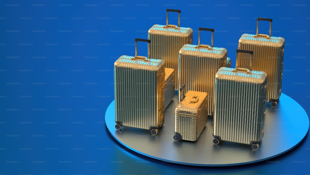 a group of four suitcases sitting on top of a blue plate