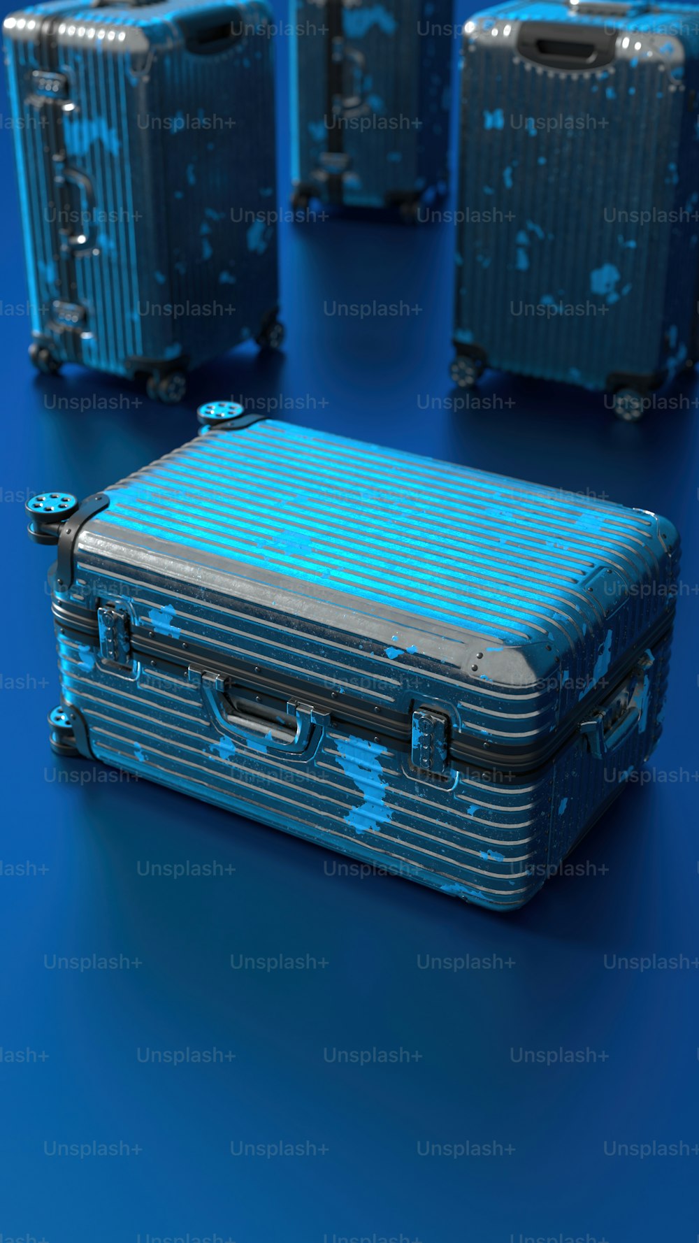 a group of blue suitcases sitting on top of a blue floor