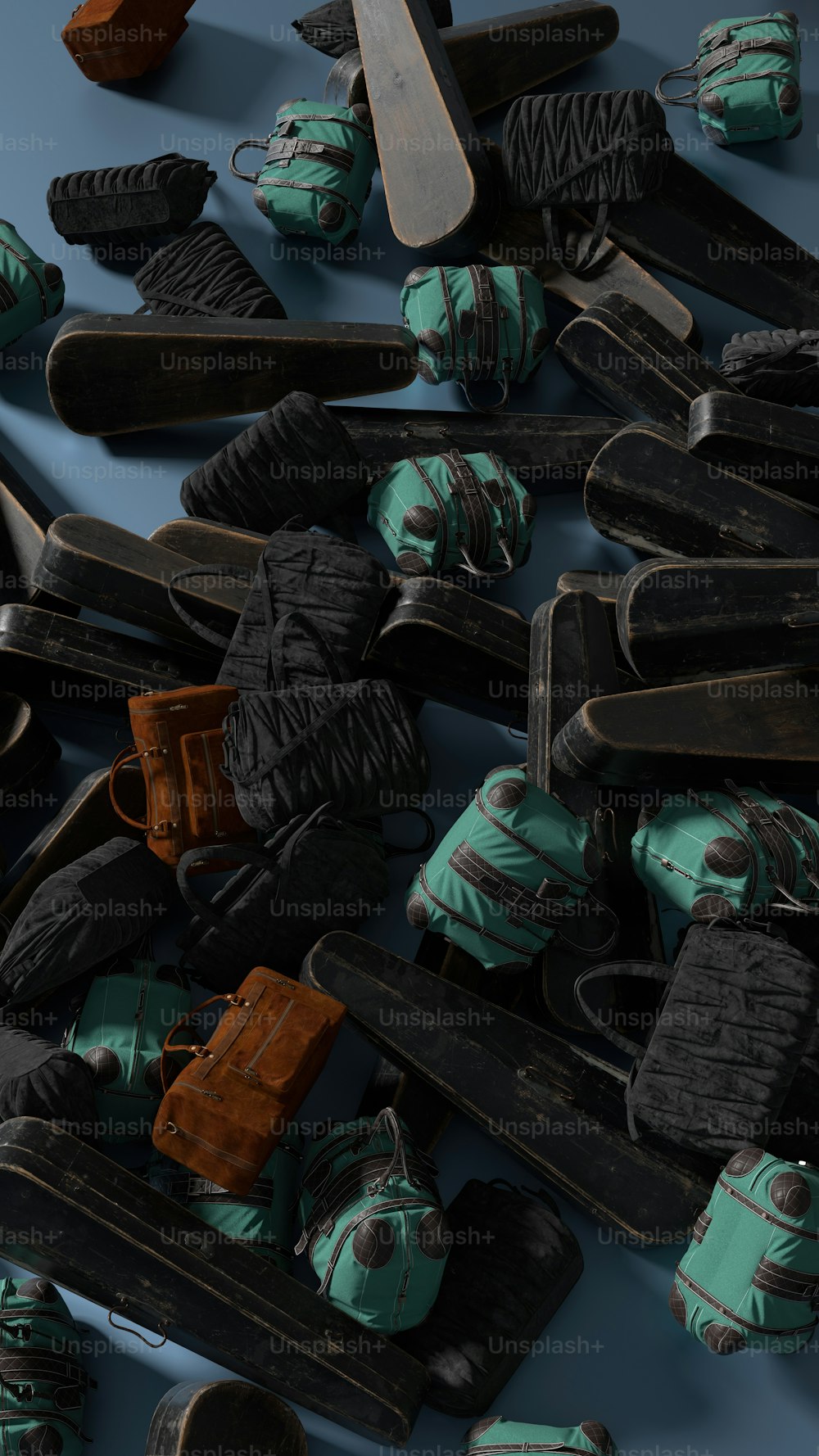 a pile of skis and snow shoes on a blue surface