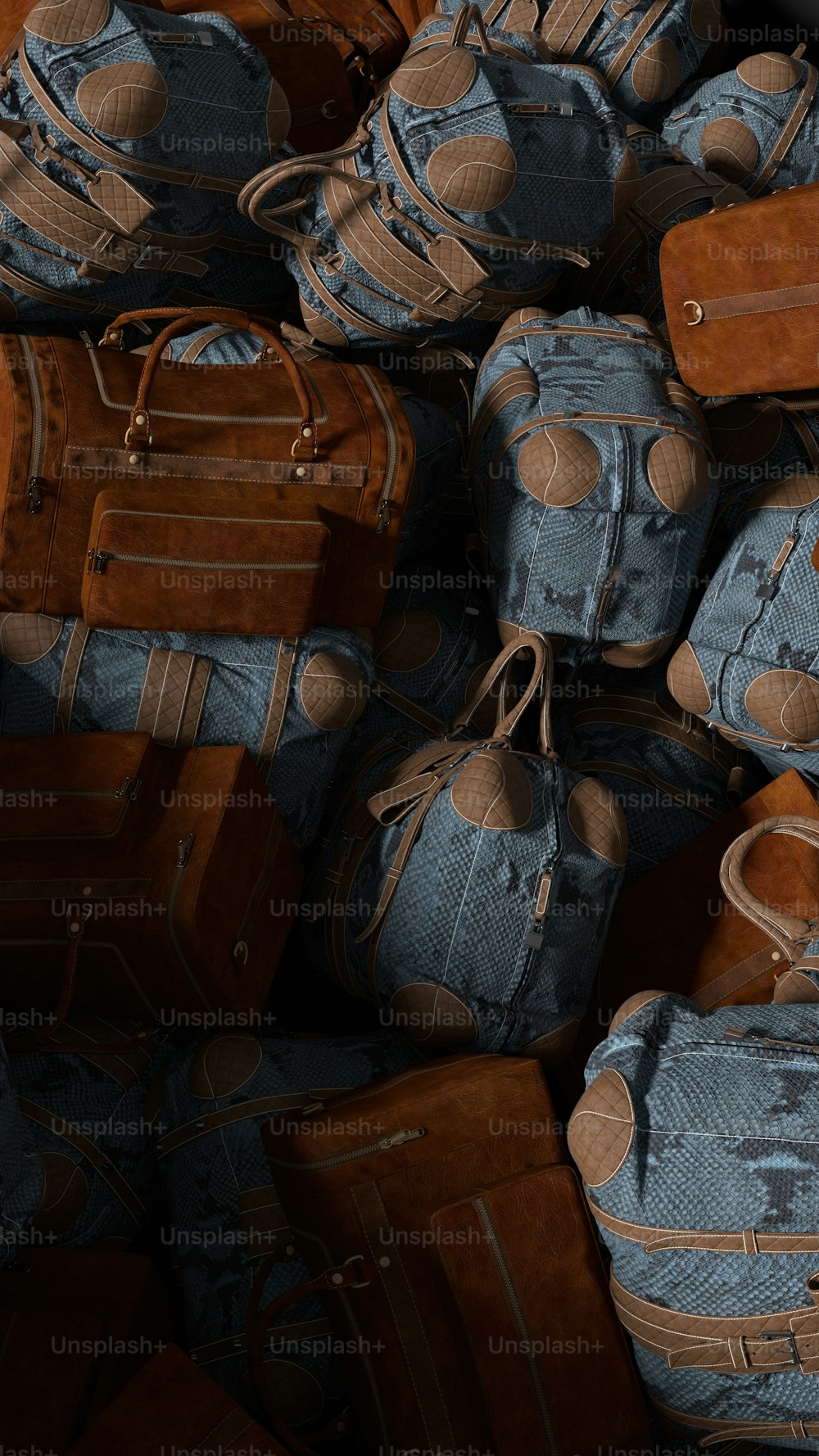 a pile of blue and brown suitcases stacked on top of each other
