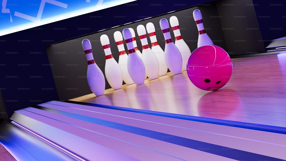 eine Kegelbahn mit Bowlingkugeln und einer rosa Kugel