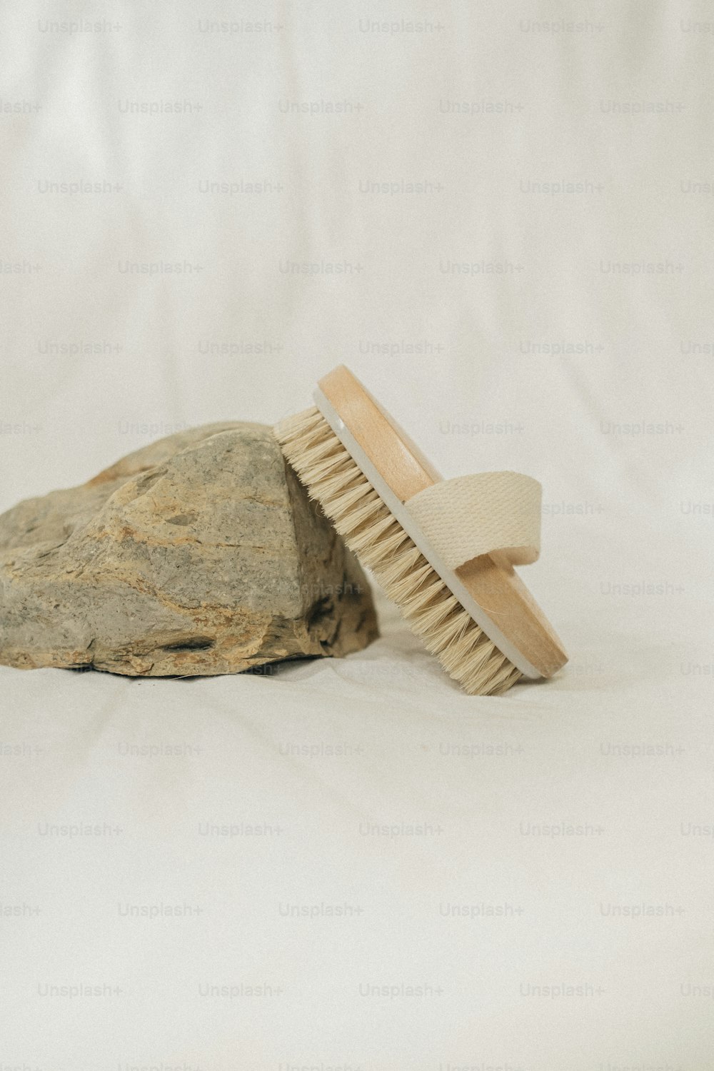 a wooden brush sitting on top of a rock