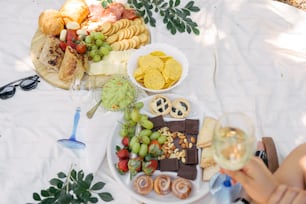a table topped with a plate of food and a glass of wine