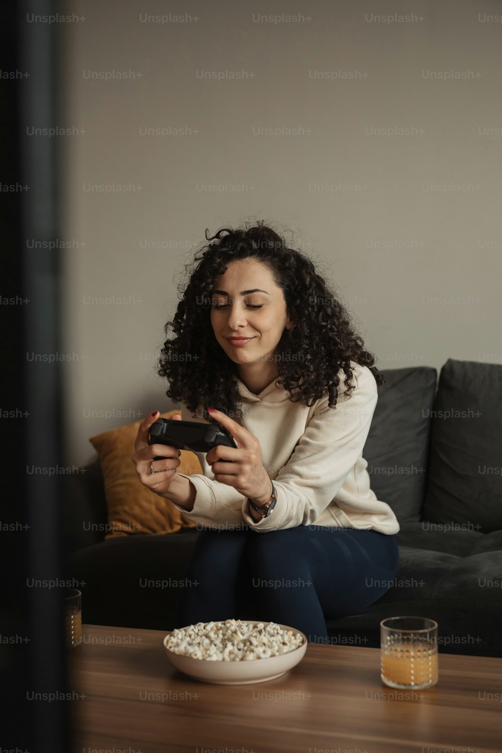 a woman sitting on a couch looking at her phone
