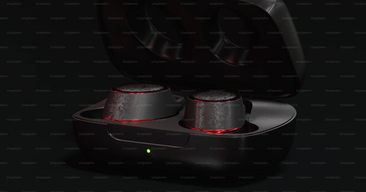 A pair of black earbuds in a case photo – Wallpaper 4k Image on Unsplash