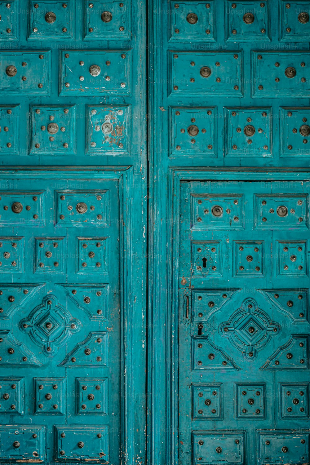 a close up of a blue door with a clock on it