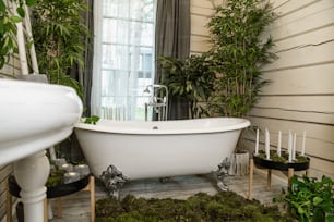 a white bath tub sitting in a bathroom next to a window