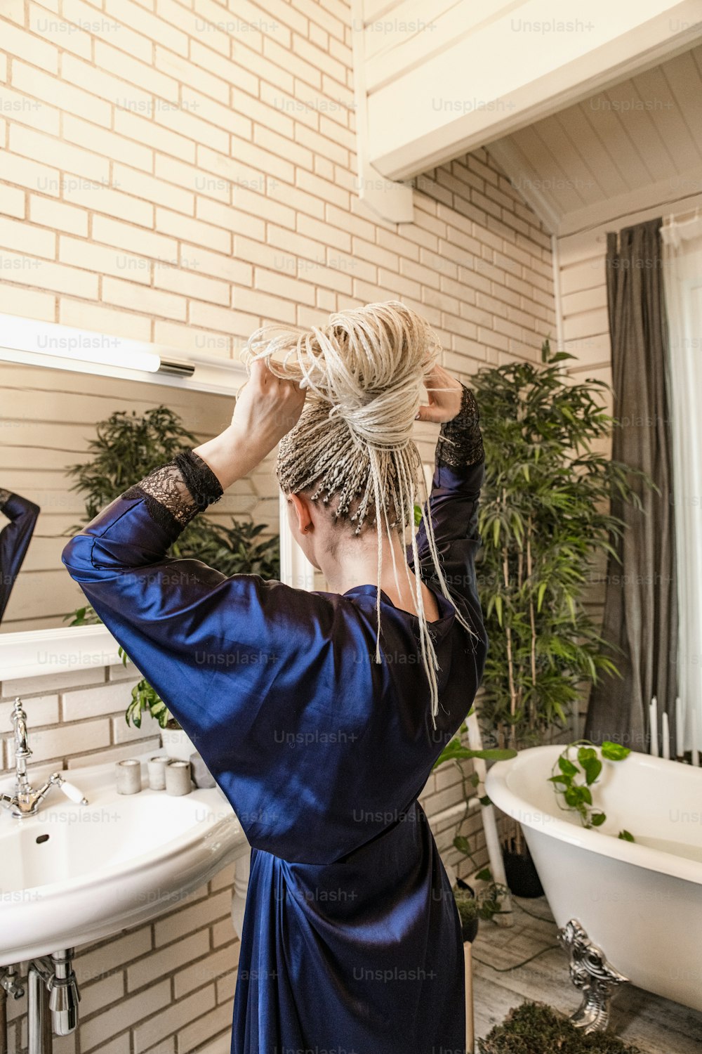 a woman in a bath room with a towel on her head