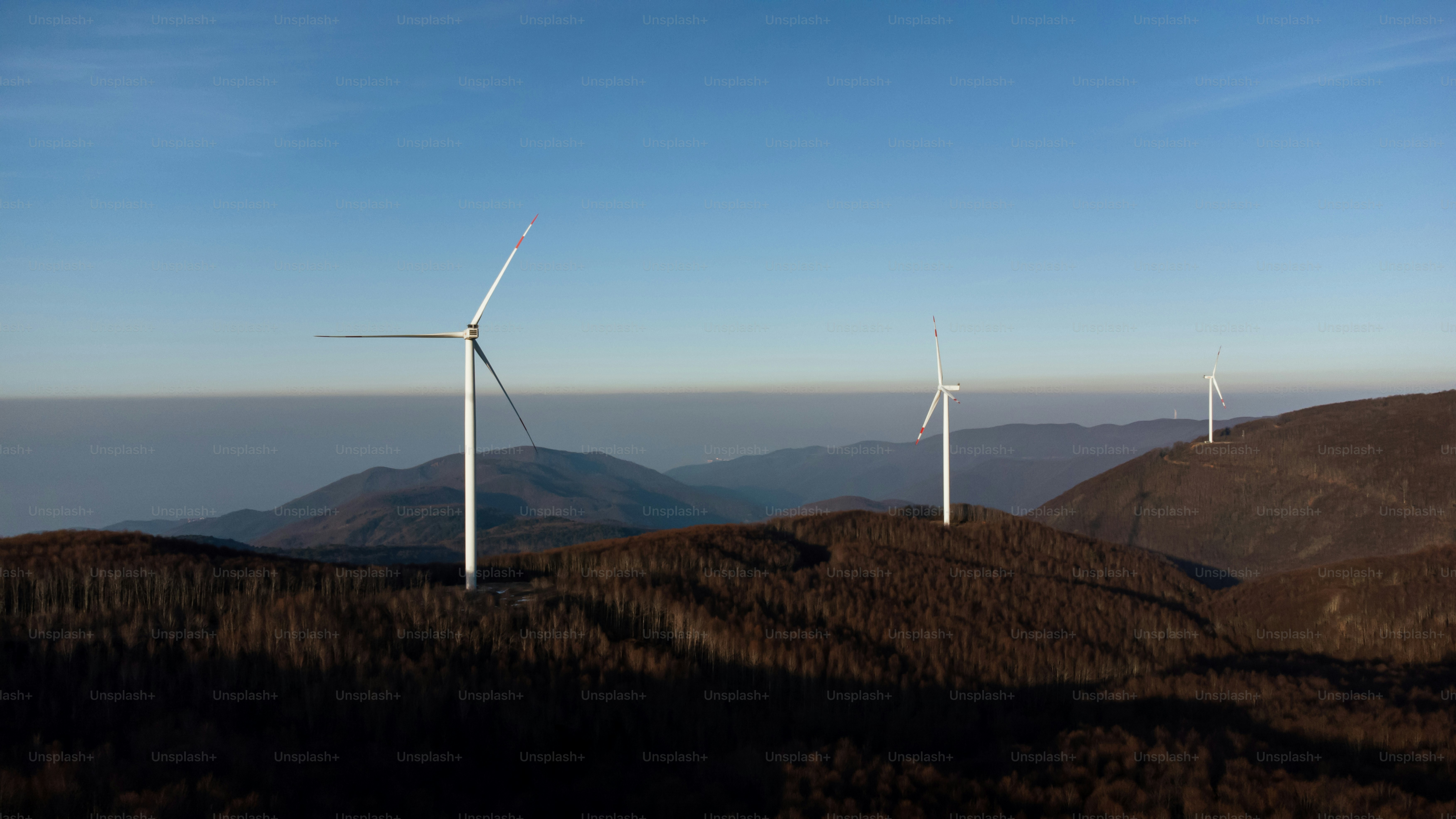 A group of wind turbines on a hill photo – Electricity Image on Unsplash