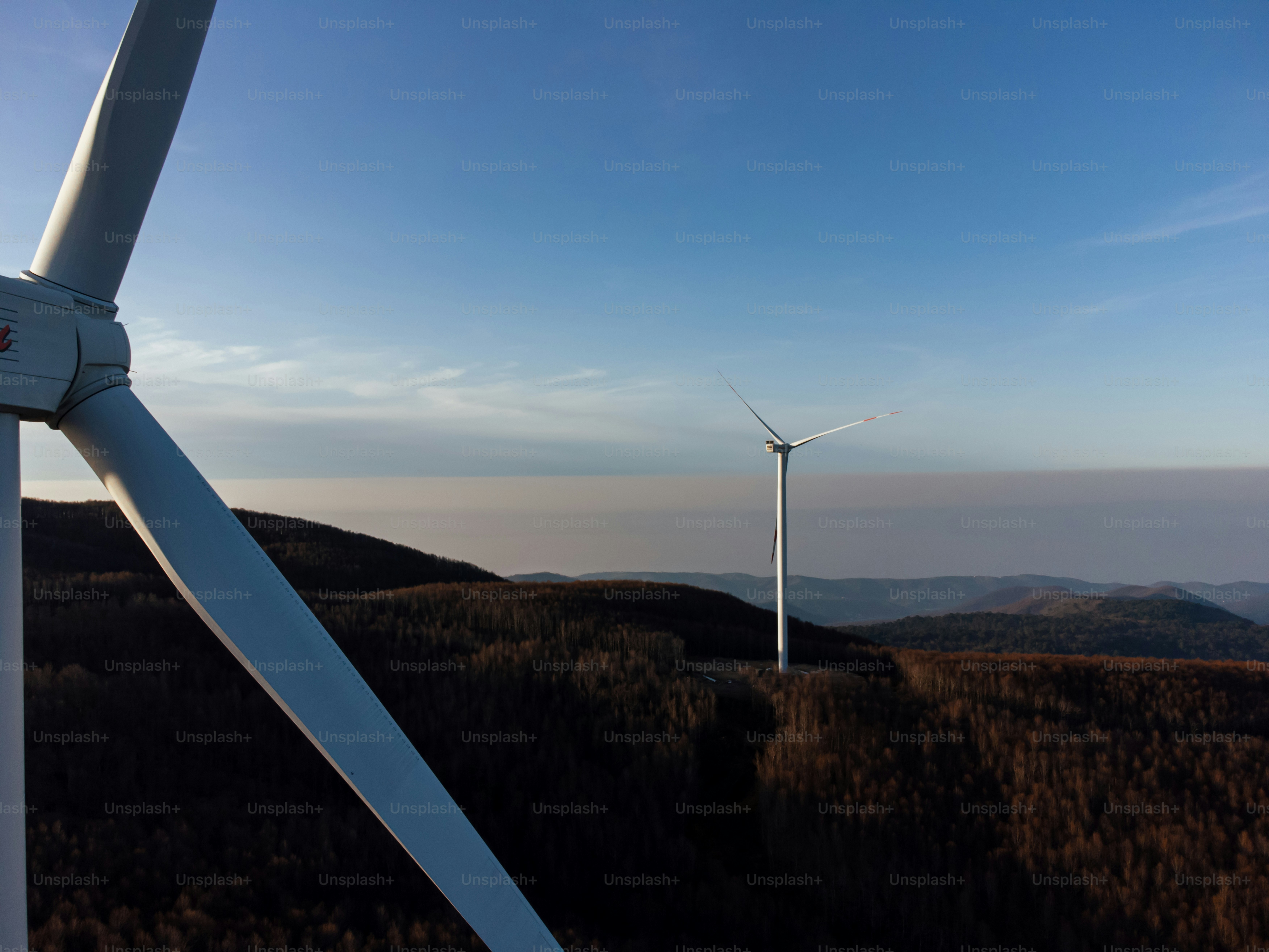 A group of wind turbines on top of a hill photo – Electricity Image on ...