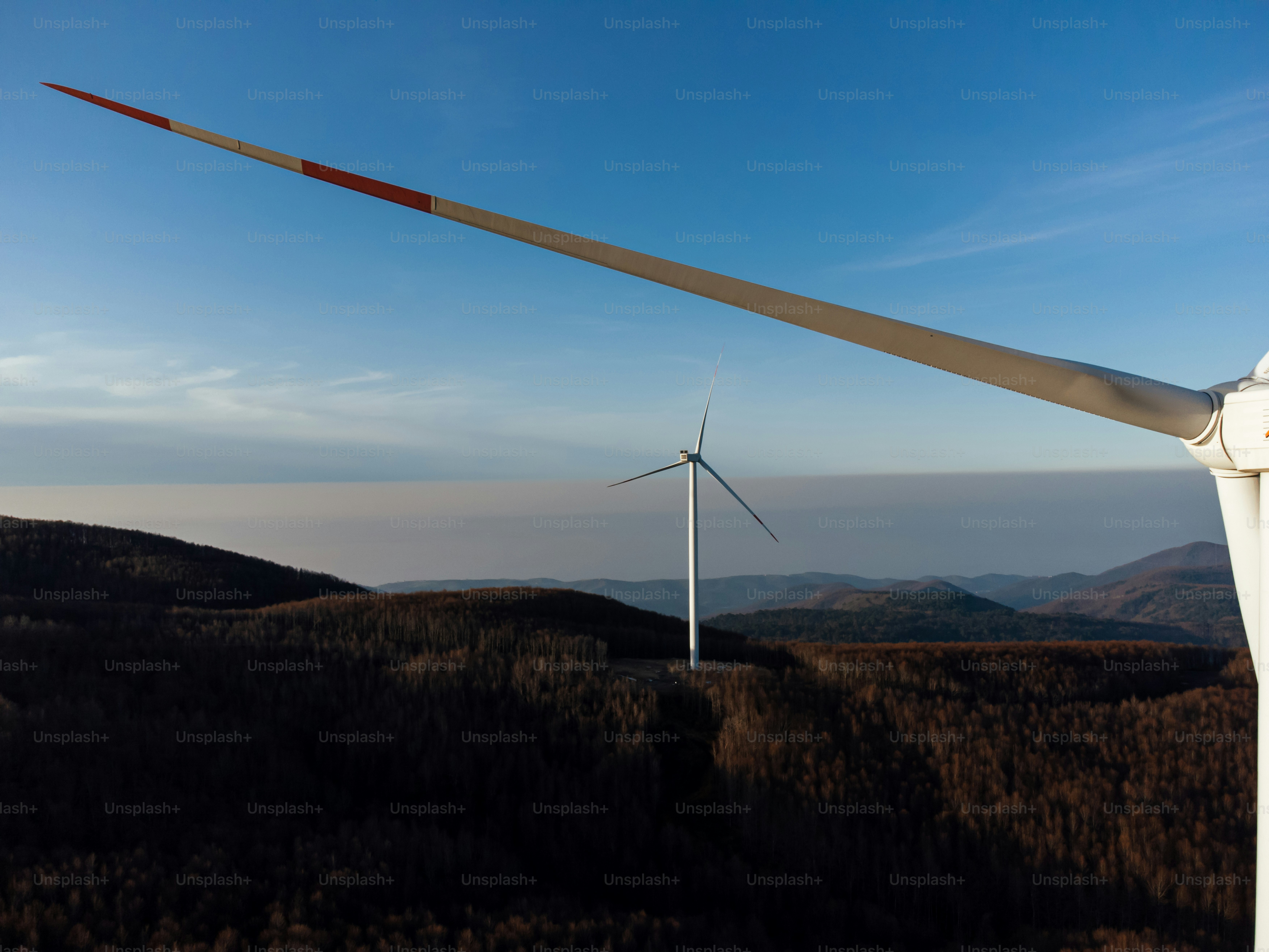 A group of wind turbines on top of a hill photo – Electricity Image on ...
