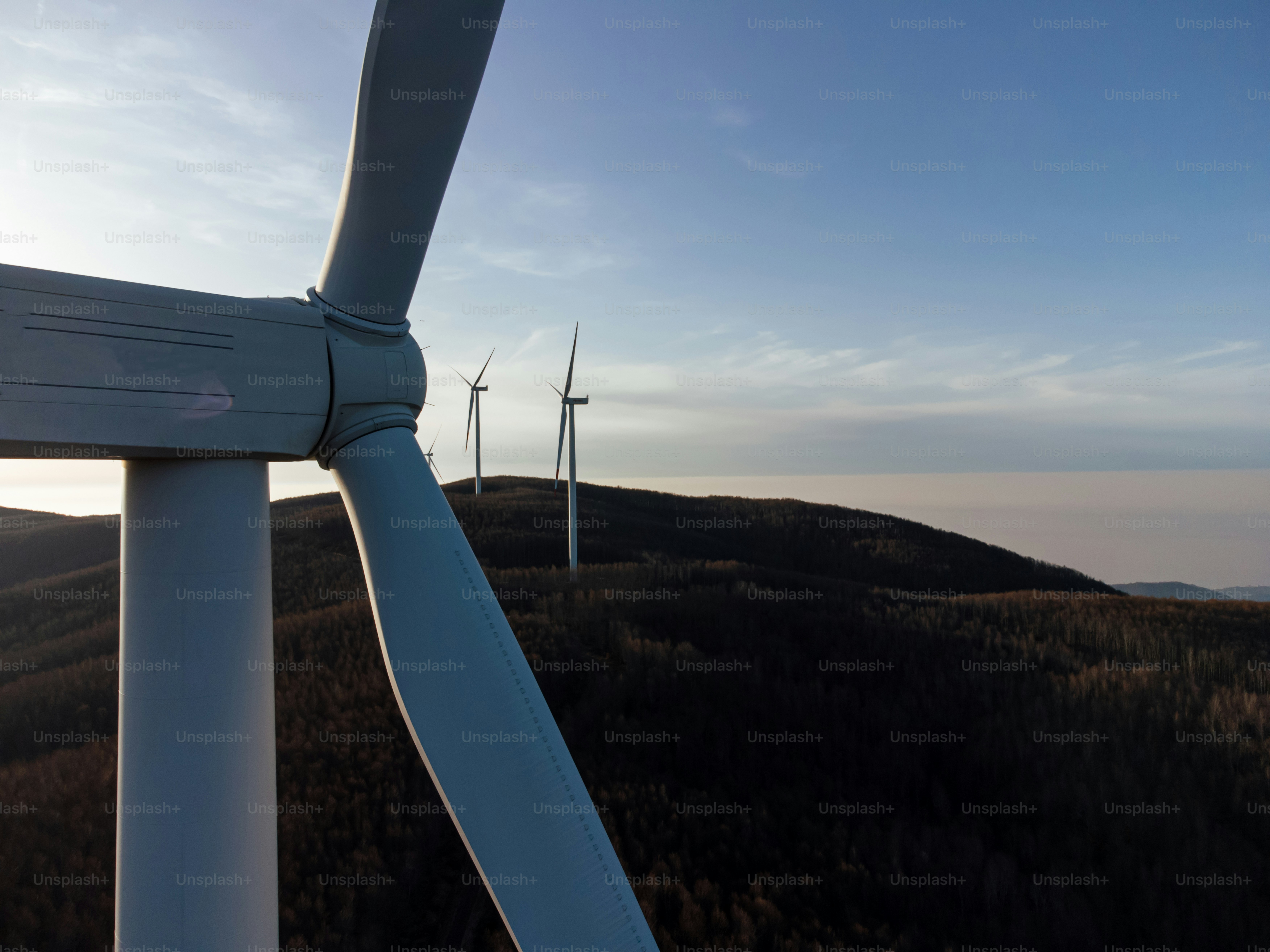 a group of wind turbines on top of a hill
