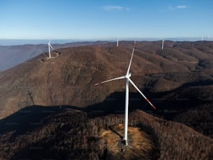 a group of wind turbines on top of a mountain