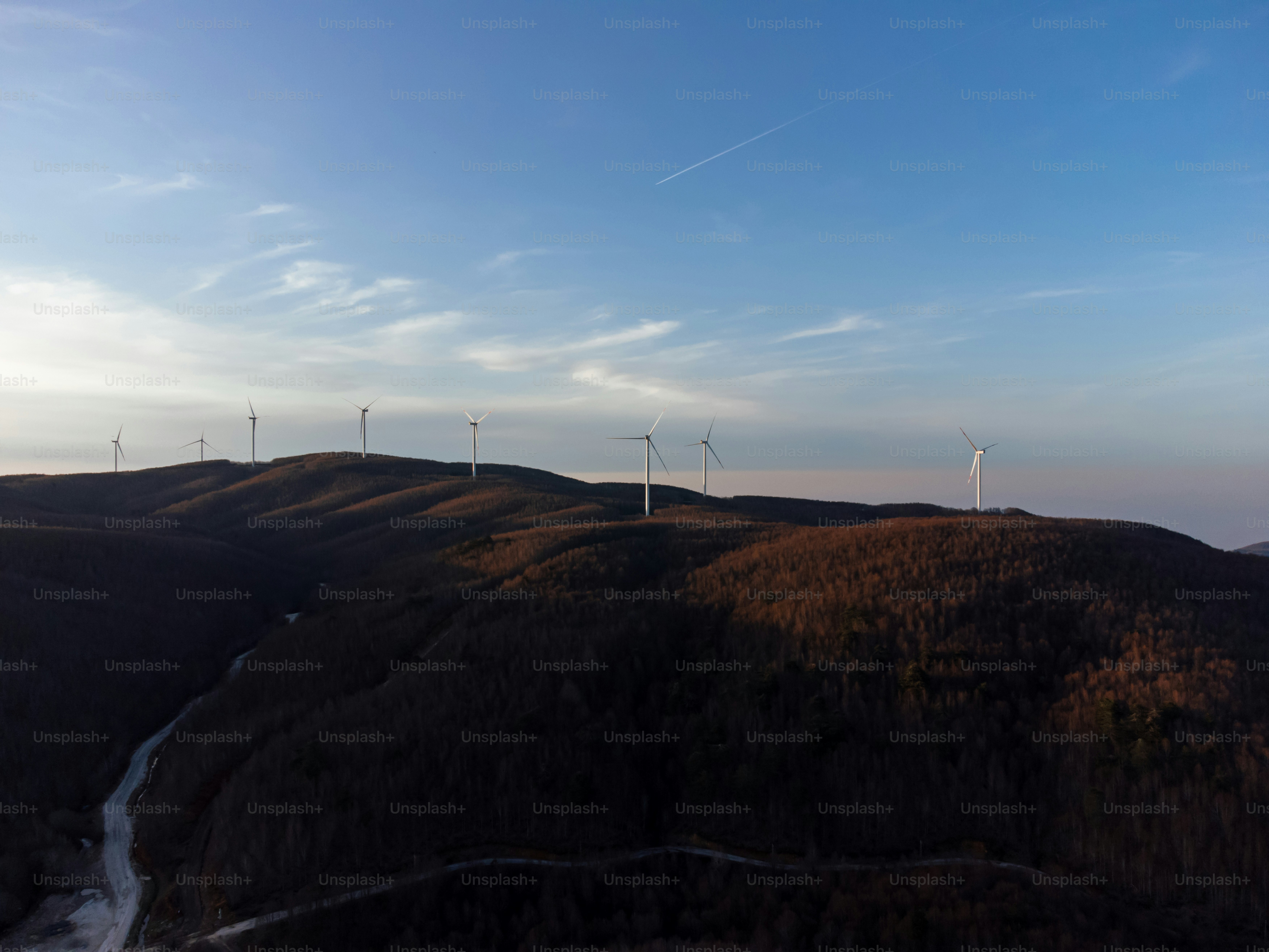 A group of wind turbines on a hill photo – Electricity Image on Unsplash