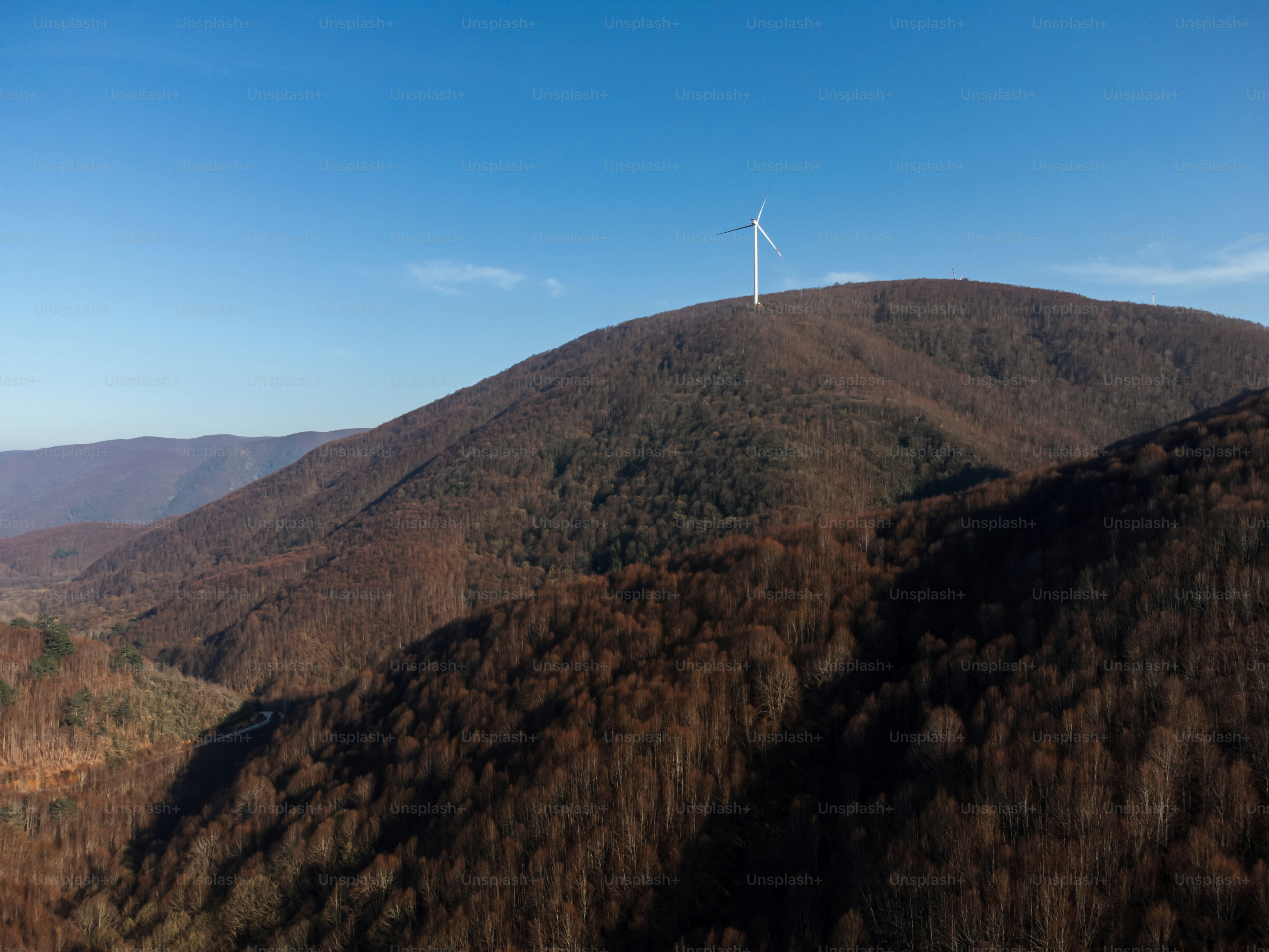 A group of wind turbines on top of a hill photo – Electricity Image on ...