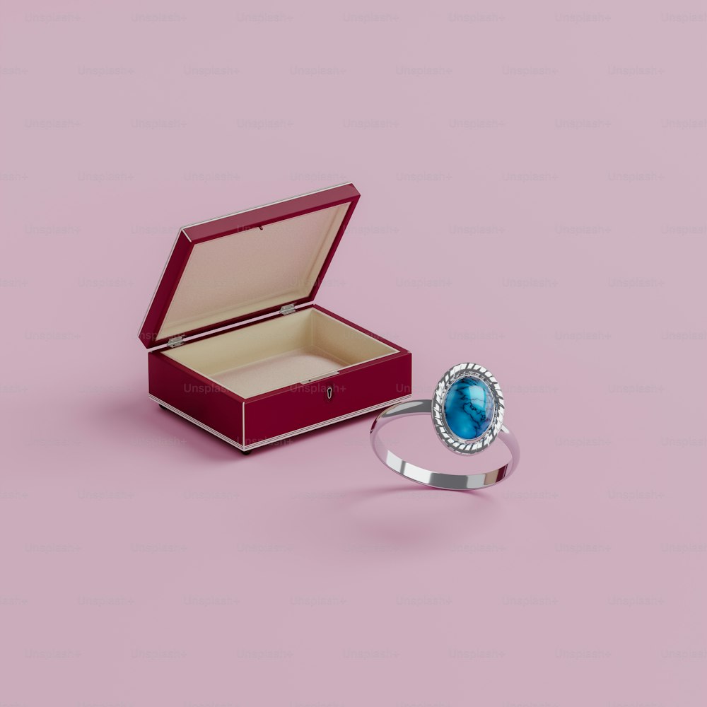 a ring with a blue stone in a red box