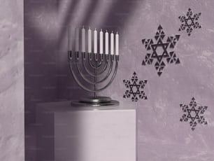 a hanukkah menorah on a pedestal in front of a wall