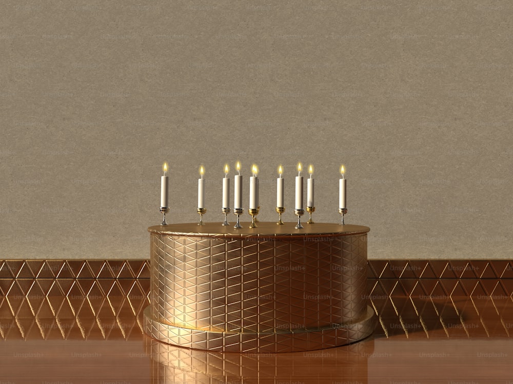 a gold cake with lit candles on top of it