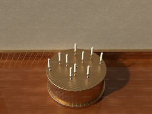 a cake with candles sitting on top of a wooden table