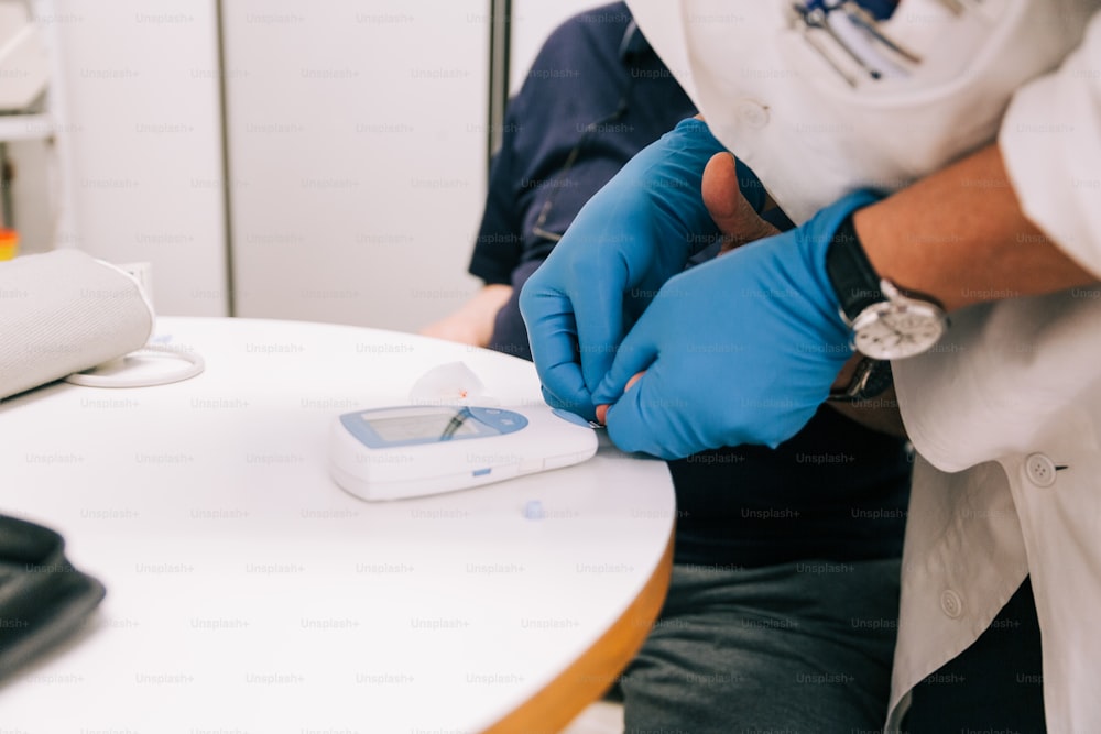 a person in a white lab coat and blue gloves