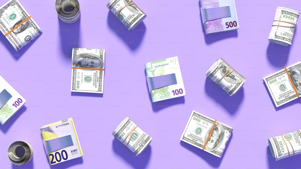 a bunch of money sitting on top of a purple surface