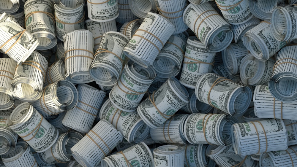 a pile of rolled up money sitting on top of each other
