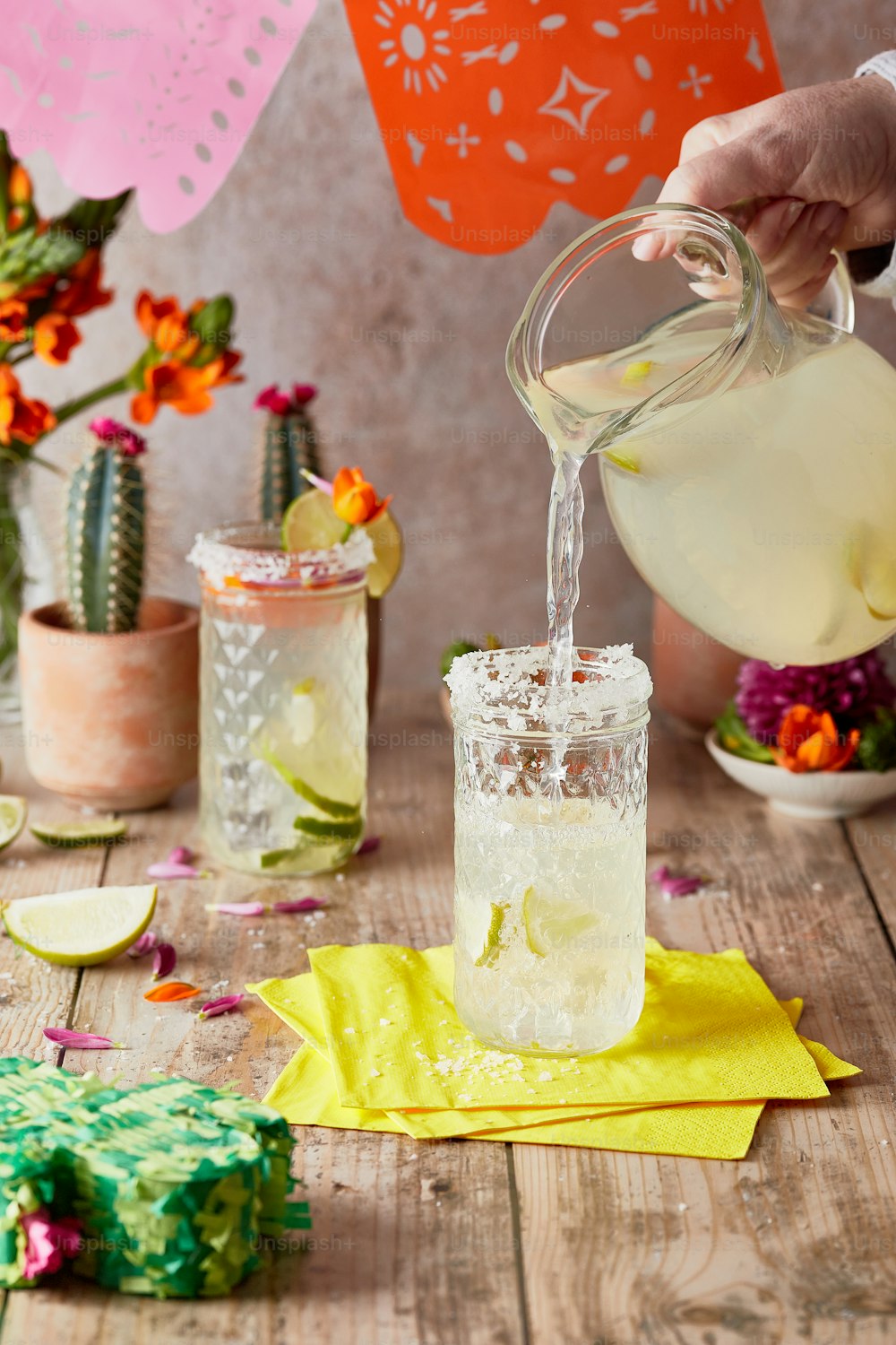 a person pouring a drink into a glass