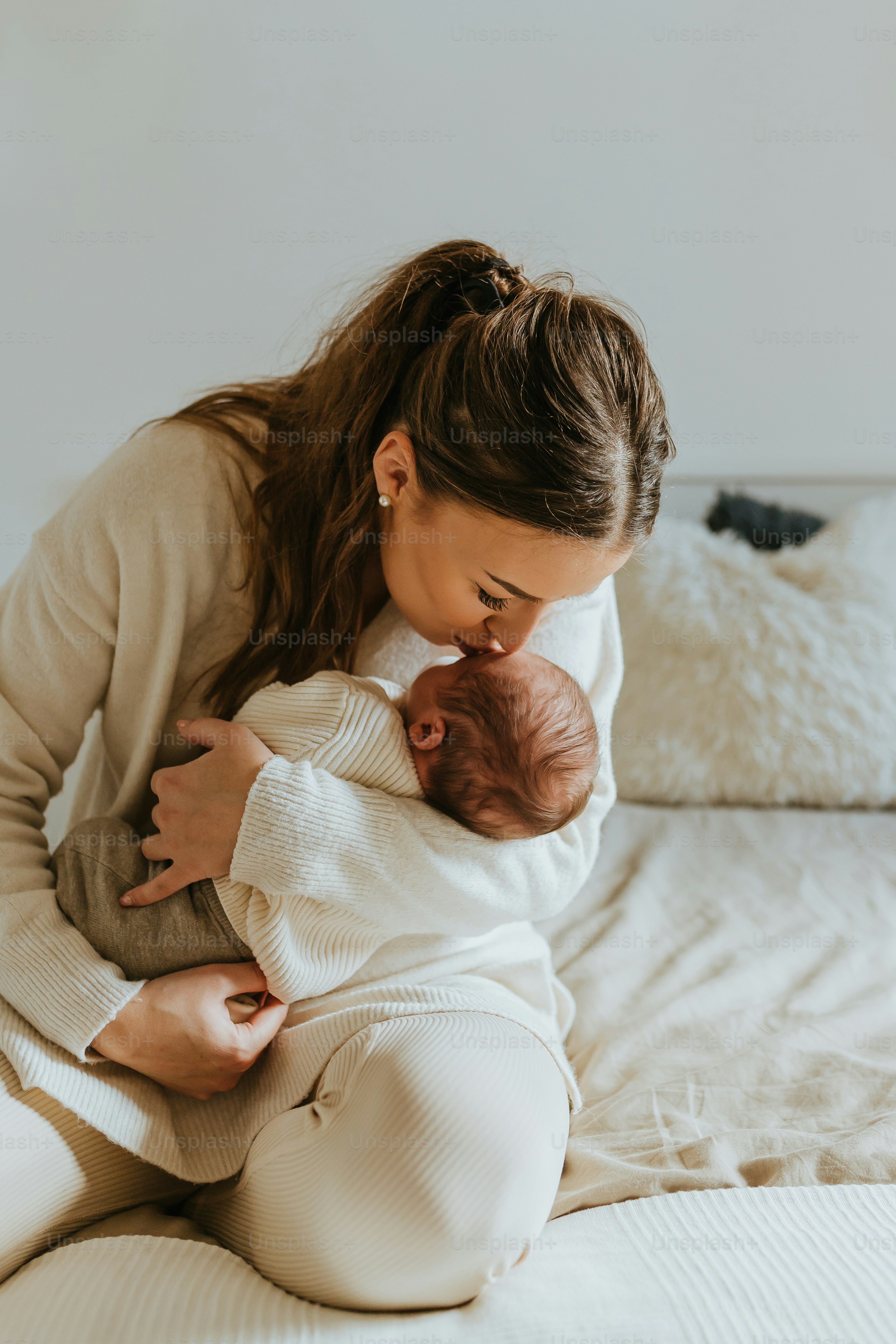 a woman holding a baby in her arms