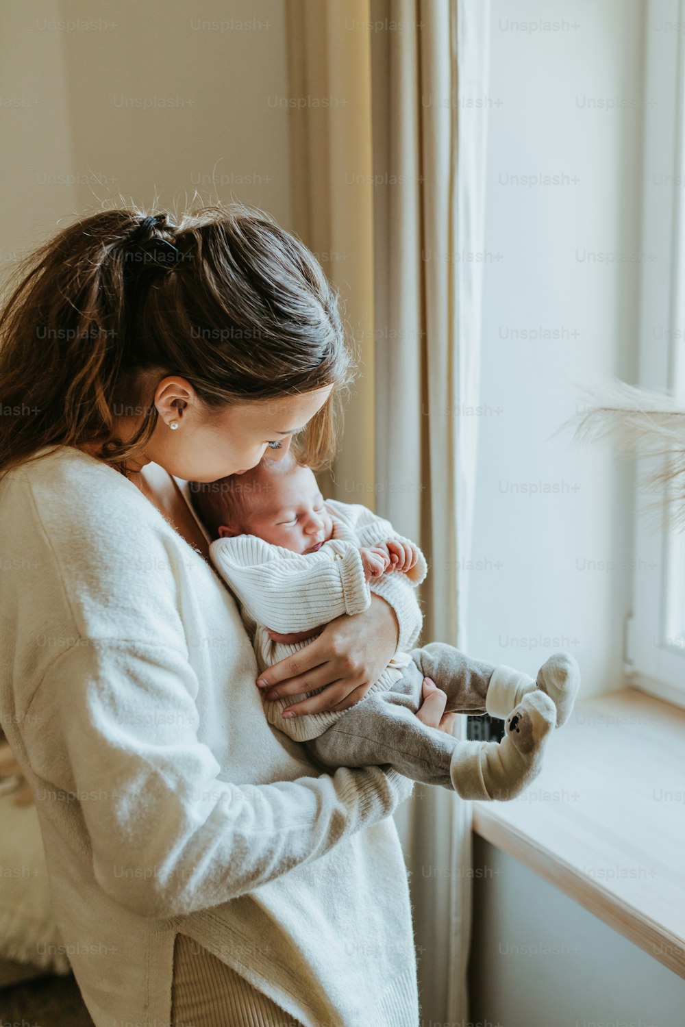 a woman holding a baby in her arms