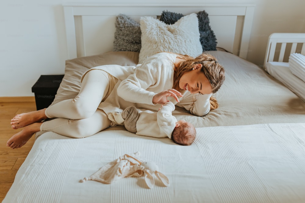 a little girl laying on top of a bed