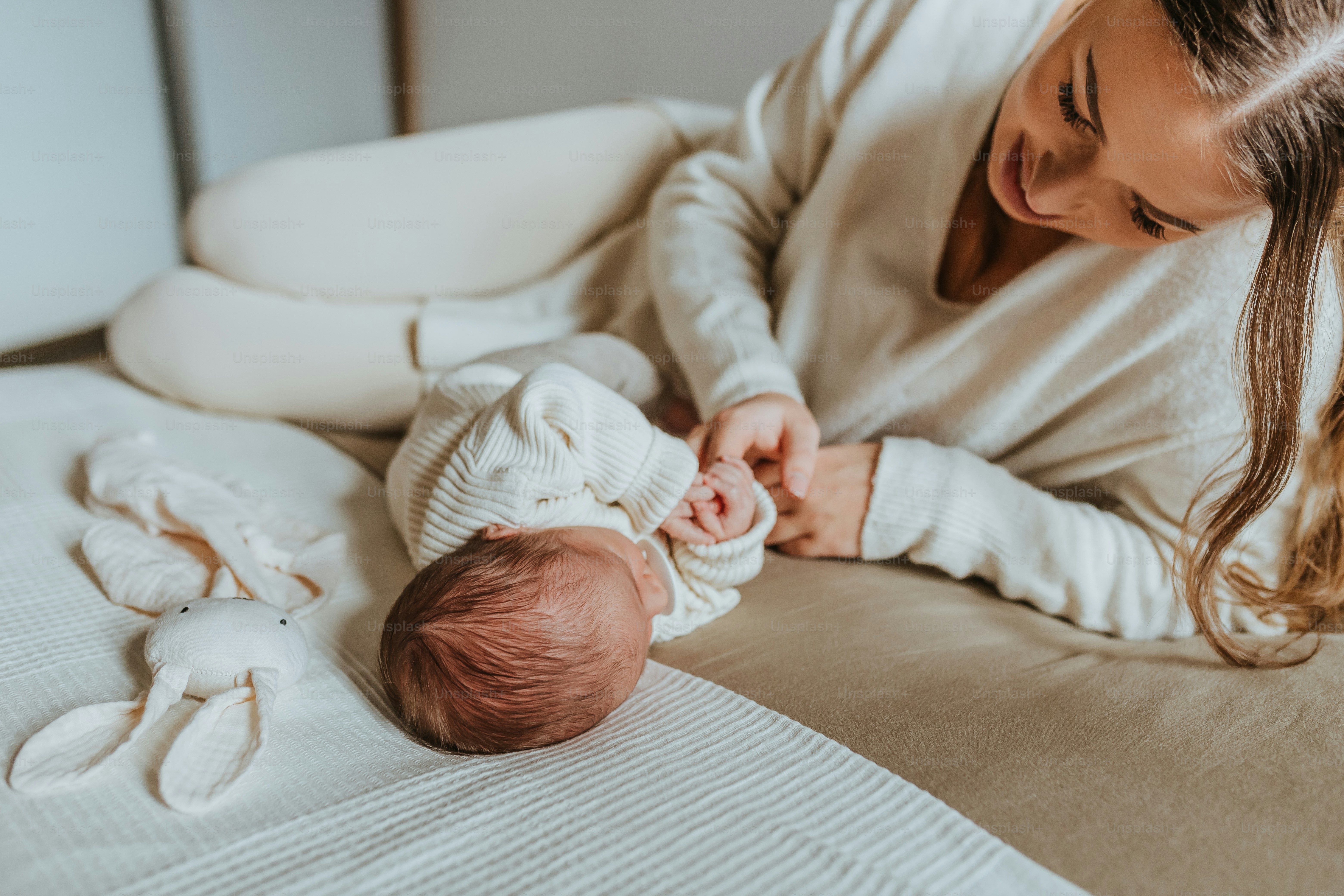 a woman is holding a baby in her arms