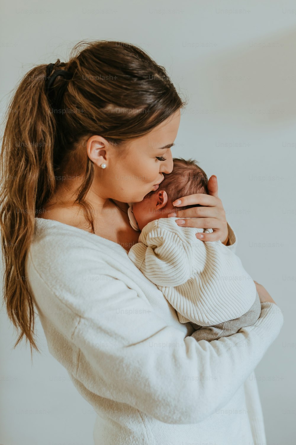 a woman holding a baby in her arms