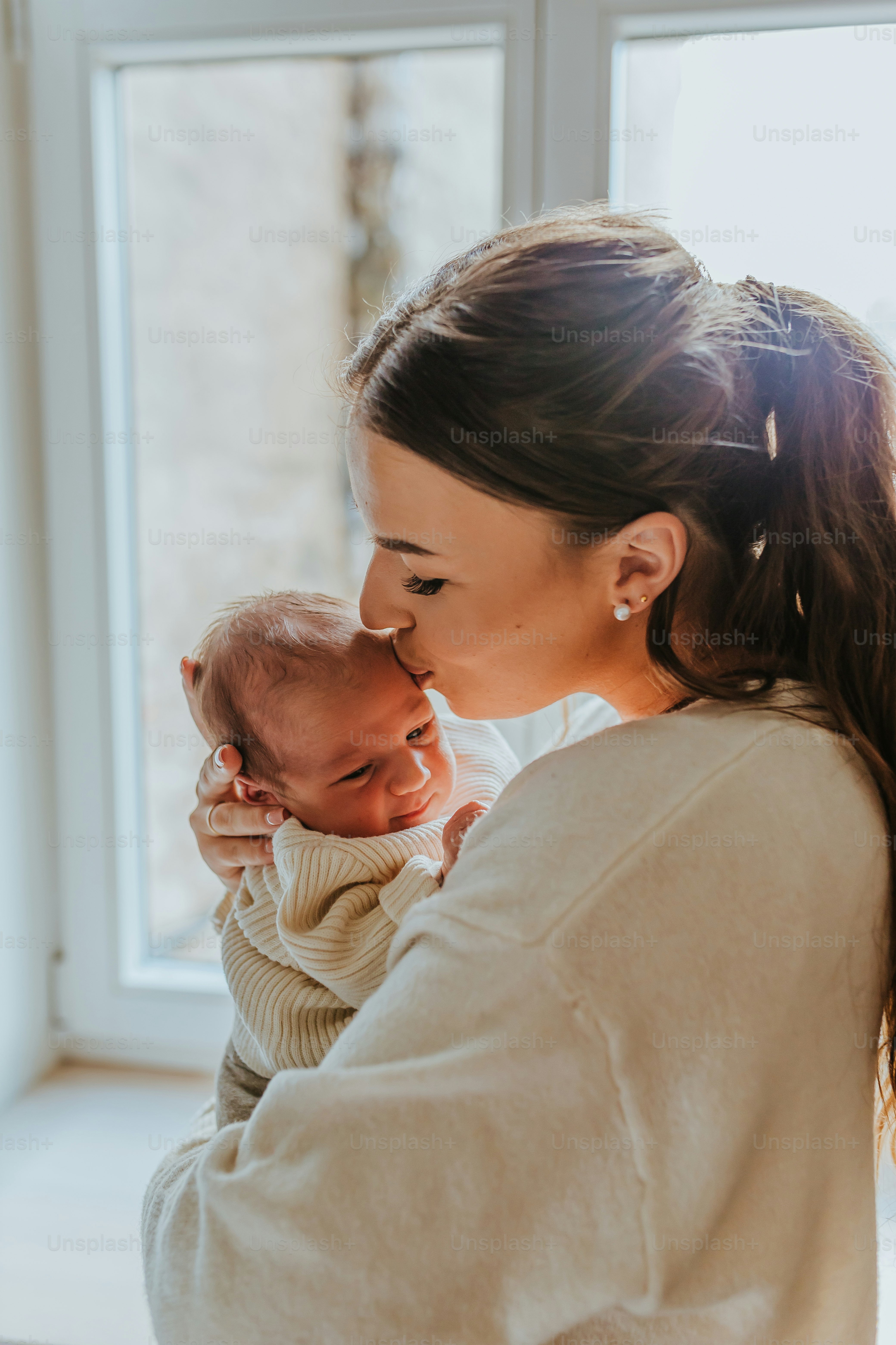 a woman holding a baby in her arms