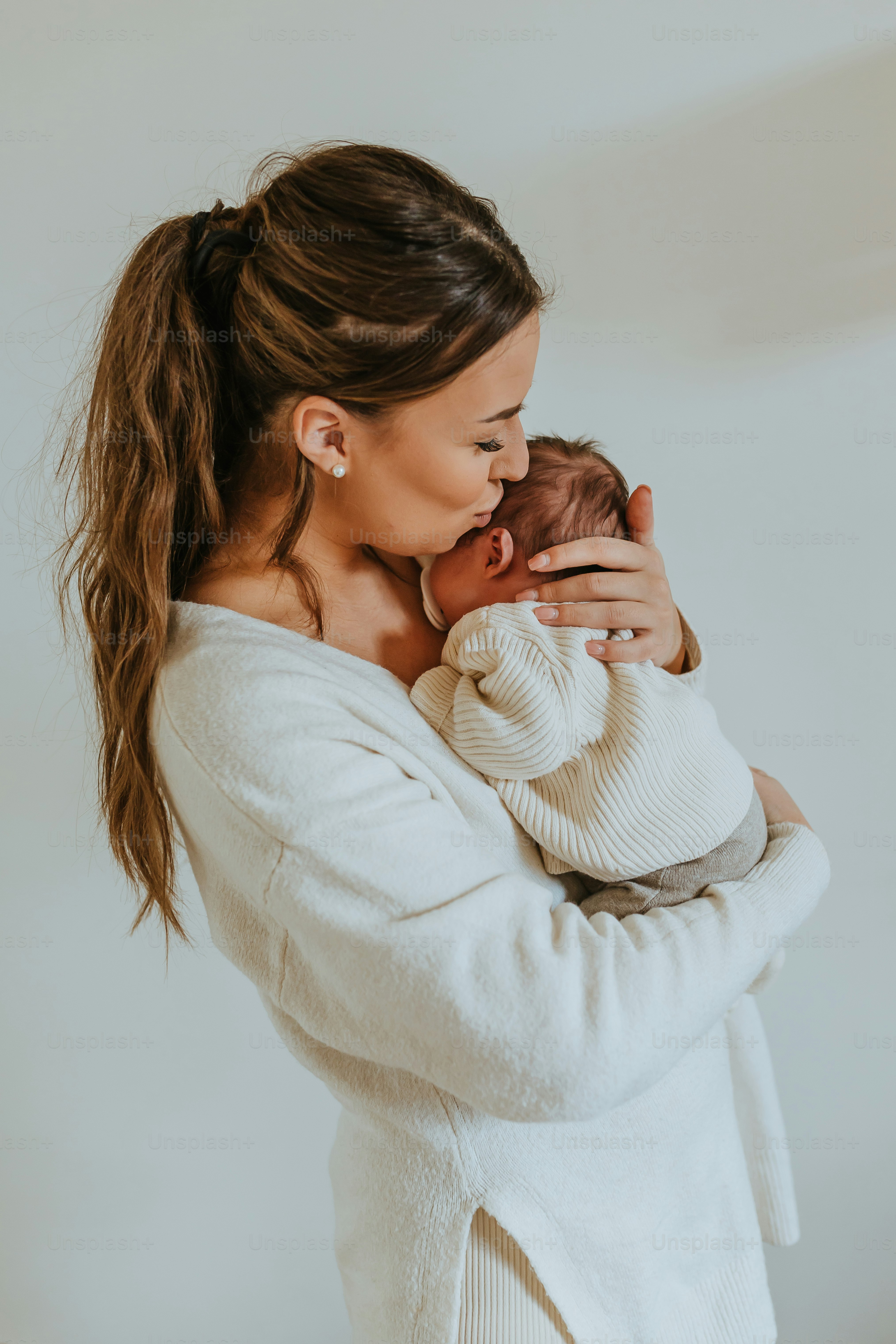 a woman holding a baby in her arms