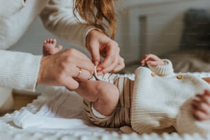 a woman putting a ring on a baby's finger