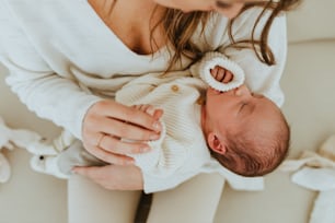 a woman holding a baby in her arms