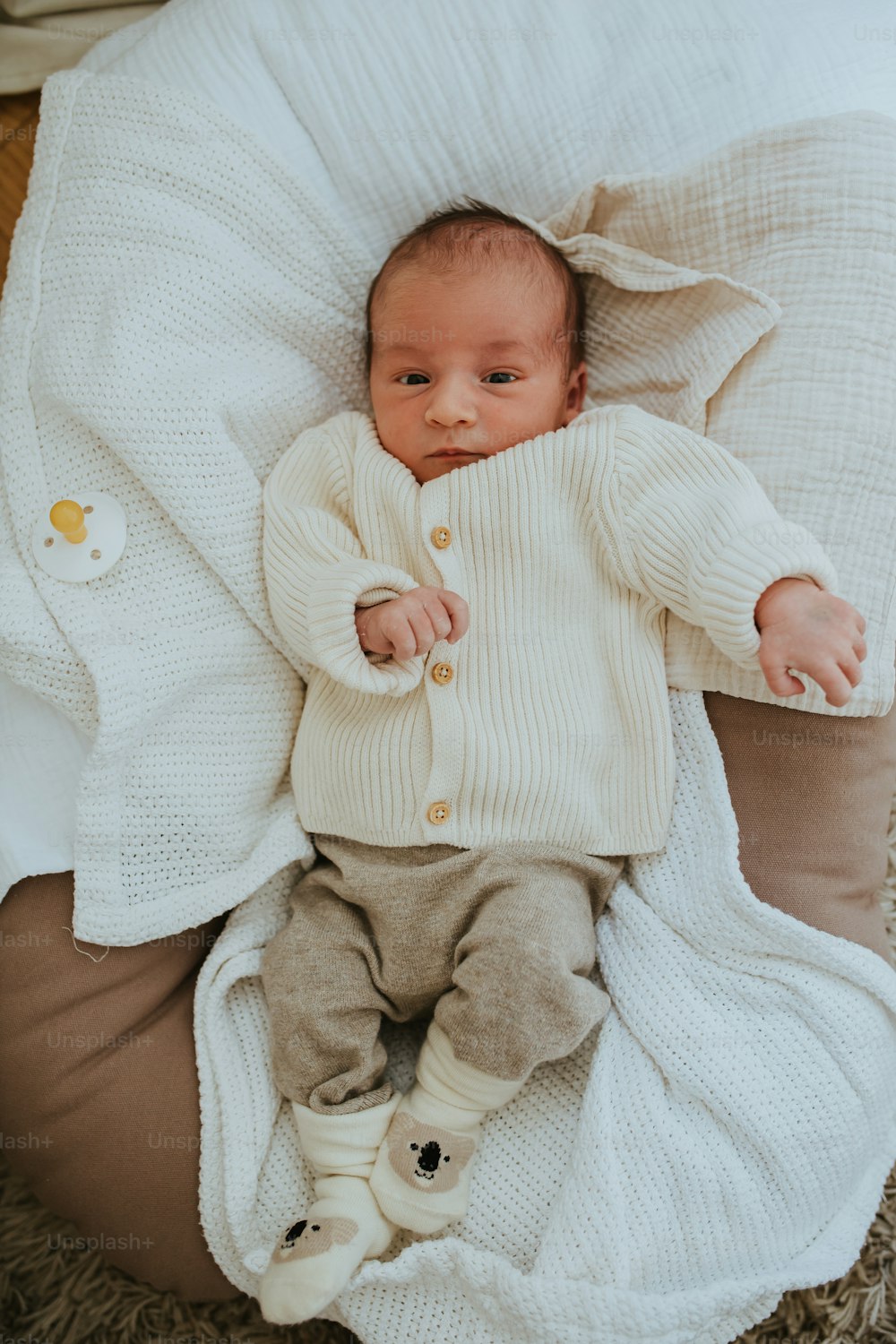 a baby laying on top of a bean bag