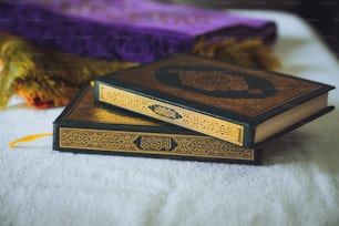 a couple of books sitting on top of a bed