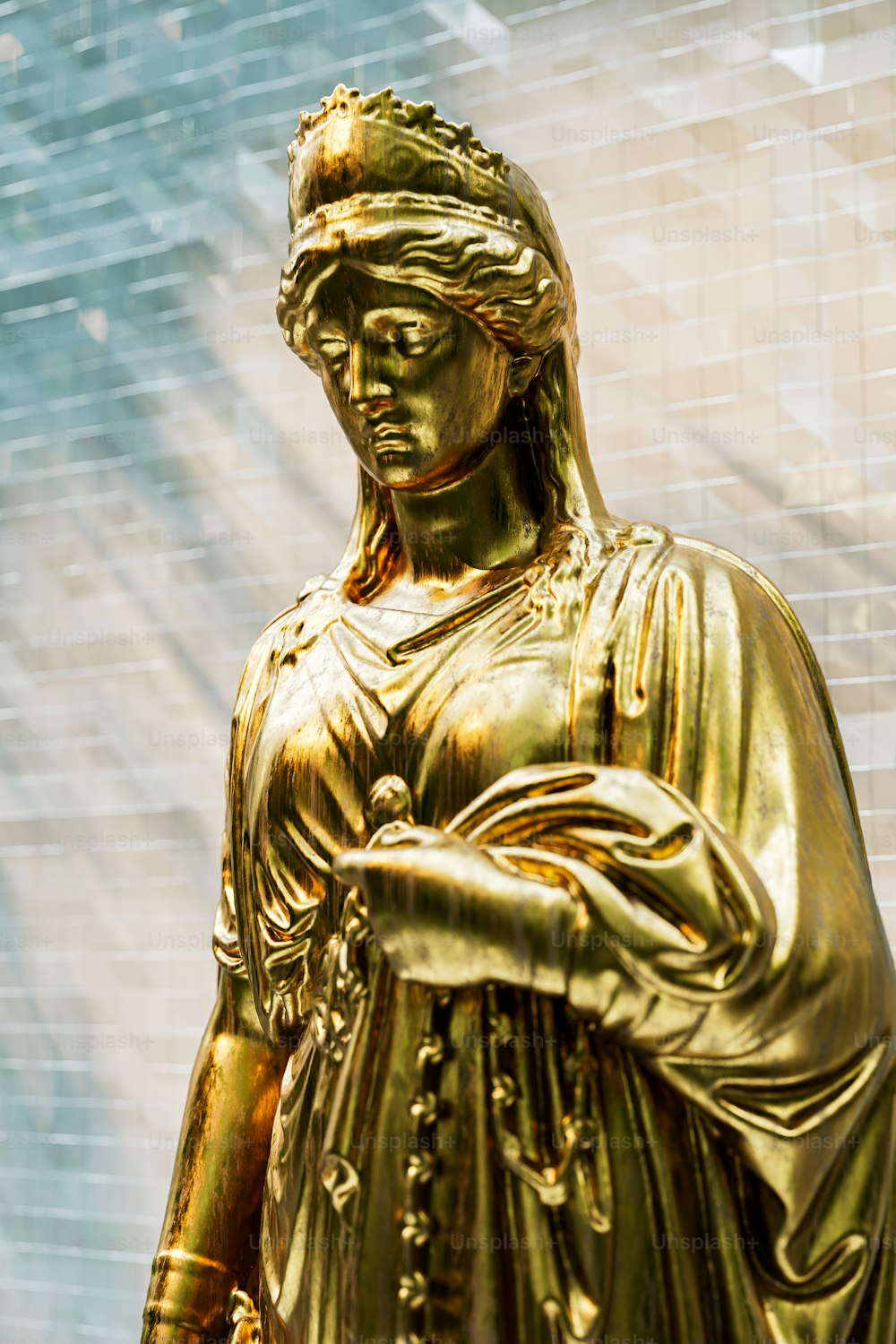 a statue of a woman holding a cell phone