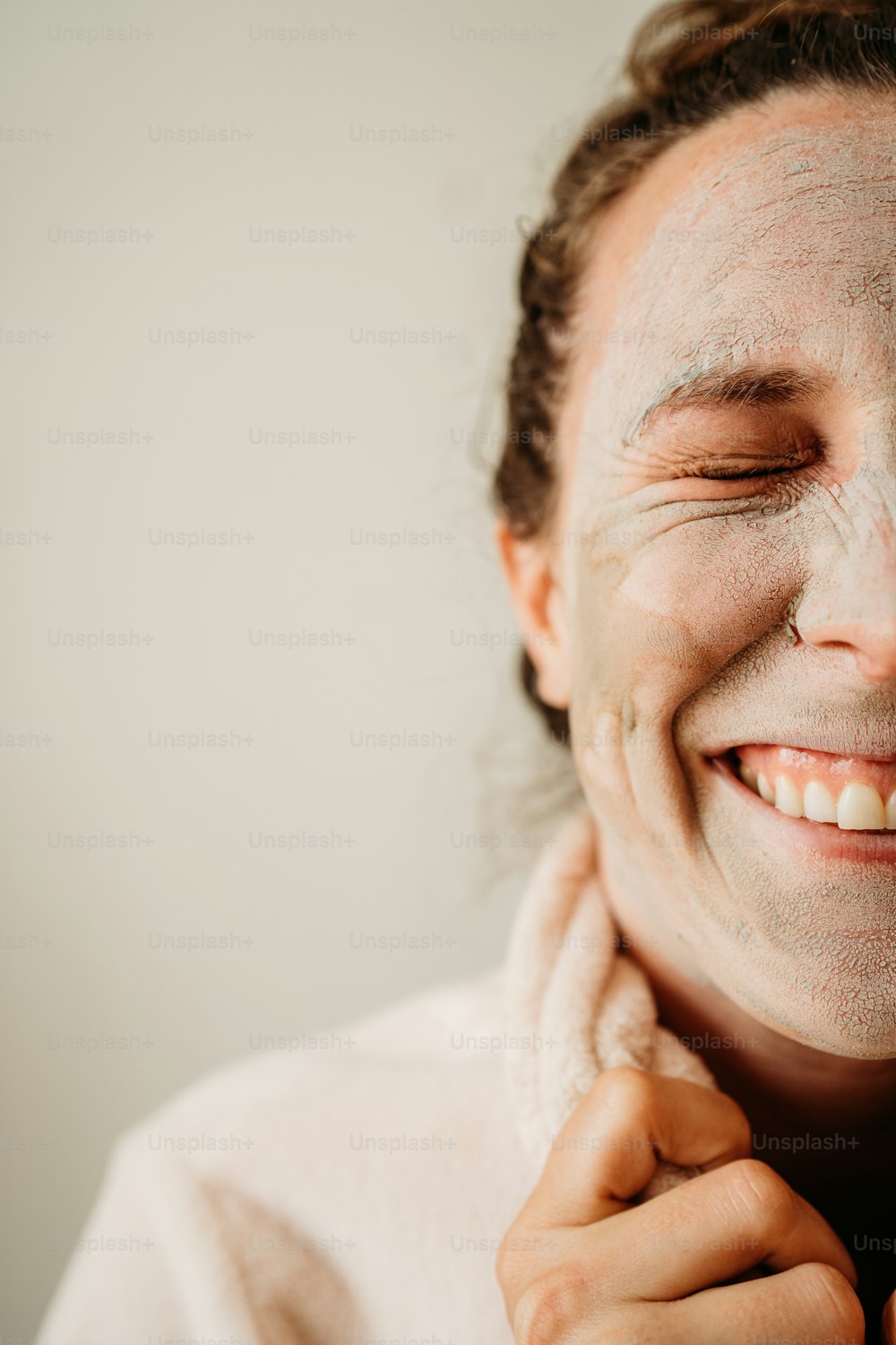 a woman with a towel around her neck smiling
