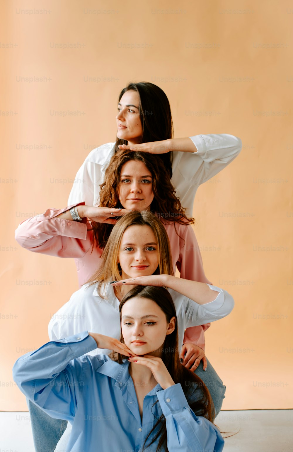 a group of women sitting on top of each other