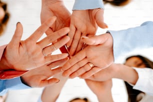 a group of people putting their hands together