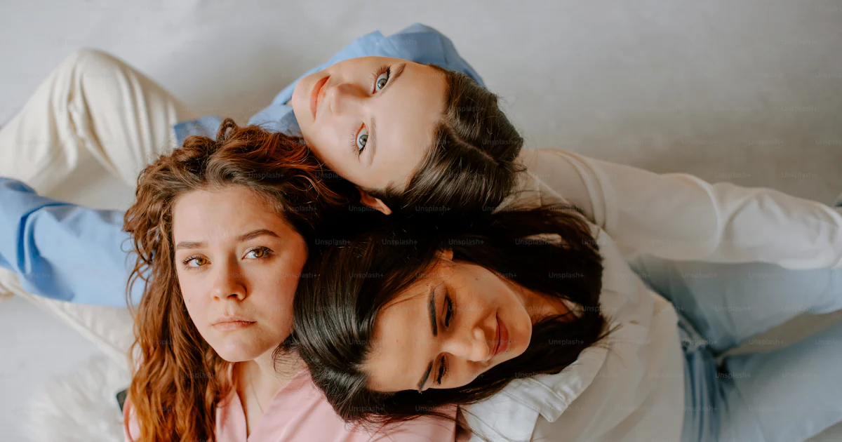 Lay Around Three women laying on the ground with their arms around each other ...