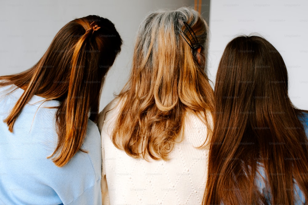 a group of three women standing next to each other