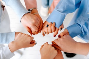 a group of people holding hands in a circle