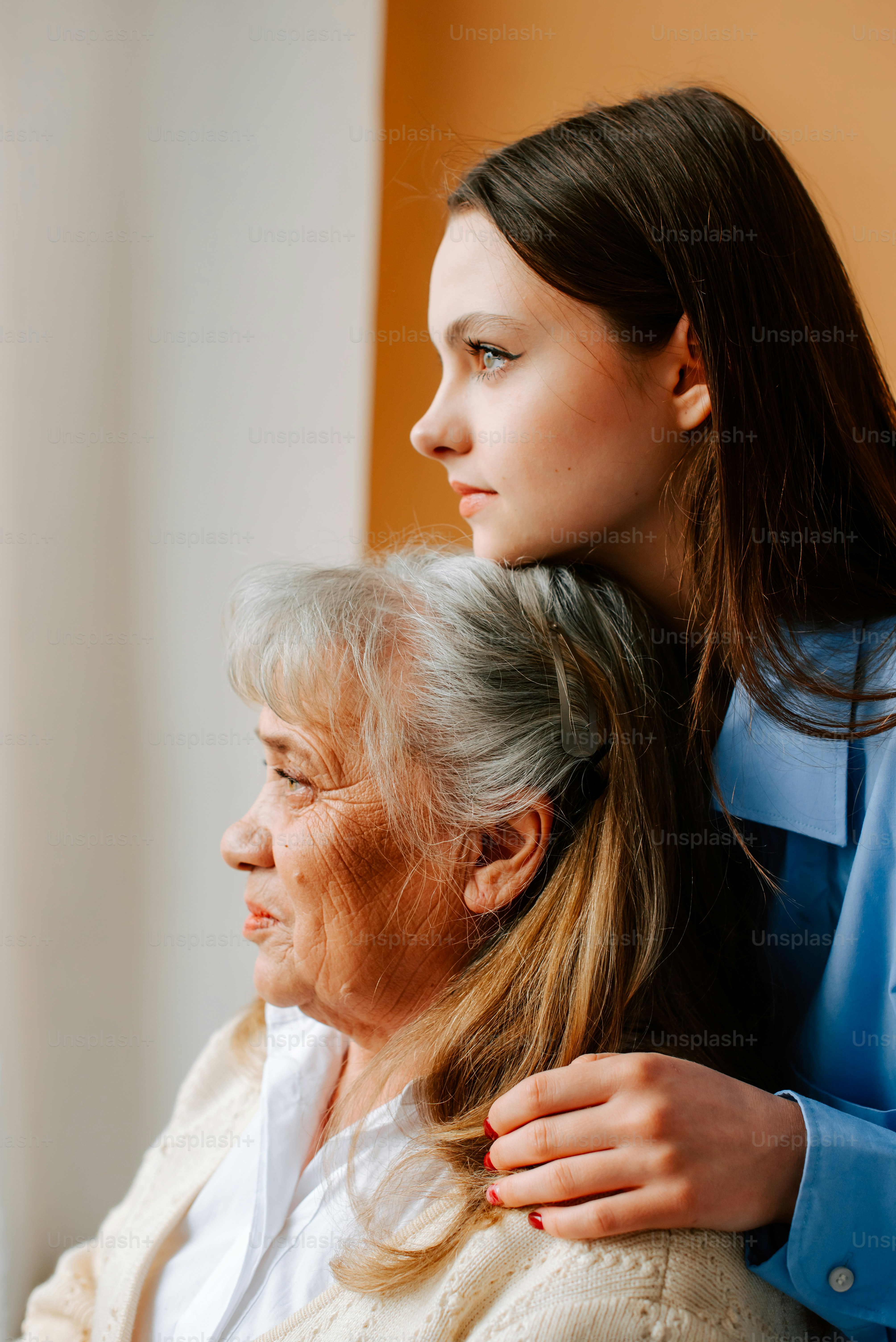 a woman getting her hair styled by an older woman